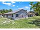 Lush backyard with a grassy lawn and gray siding on the exterior of the home at 722 Ridgewood Way, Winter Springs, FL 32708