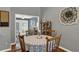 Dining area featuring a round table, four chairs, hardwood floors, and neutral wall color at 722 Ridgewood Way, Winter Springs, FL 32708