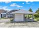Home exterior featuring a carport, concrete driveway, and neutral gray siding with a well-manicured yard at 722 Ridgewood Way, Winter Springs, FL 32708