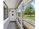 Front porch featuring a welcome mat, a white trimmed screen, and a decorative hanging wind chime at 722 Ridgewood Way, Winter Springs, FL 32708