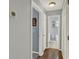 Hallway with access to the bathroom with wood flooring and gray walls at 722 Ridgewood Way, Winter Springs, FL 32708