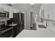 Modern kitchen featuring stainless steel appliances, white cabinets, and tile flooring at 722 Ridgewood Way, Winter Springs, FL 32708