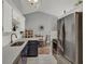 Modern kitchen featuring stainless steel appliances, dark lower cabinets, white upper cabinets, and tile floor at 722 Ridgewood Way, Winter Springs, FL 32708