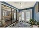 Bright sunroom with checkered tile floor, opening to Primary bedroom and the backyard at 722 Ridgewood Way, Winter Springs, FL 32708
