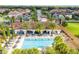 Aerial view of community pool and clubhouse surrounded by manicured landscaping and residential homes at 8419 Pippen Dr, Orlando, FL 32836
