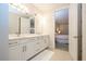 Bright bathroom with double vanity and access to walk in closet and a connecting bedroom at 8419 Pippen Dr, Orlando, FL 32836