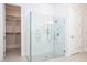 Glass shower with seating and shower-head in primary bathroom with walk-in closet at 8419 Pippen Dr, Orlando, FL 32836