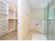 Bright bathroom with a glass enclosed shower and a large walk-in closet with built-in shelving at 8419 Pippen Dr, Orlando, FL 32836