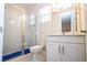 Well-lit bathroom featuring a glass shower, white fixtures, and vanity with plenty of counter space at 8419 Pippen Dr, Orlando, FL 32836
