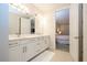 Bright bathroom with double vanity and access to walk in closet and a connecting bedroom at 8419 Pippen Dr, Orlando, FL 32836