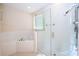 Modern bathroom with a glass-enclosed shower and soaking tub, showcasing a relaxing atmosphere at 8419 Pippen Dr, Orlando, FL 32836