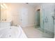 Modern bathroom featuring a glass-enclosed shower and a luxurious soaking tub at 8419 Pippen Dr, Orlando, FL 32836