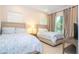 Bright bedroom featuring two cozy beds, neutral decor, and tile flooring at 8419 Pippen Dr, Orlando, FL 32836