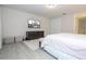 Well-lit bedroom featuring wood flooring, large dresser, and mounted television for entertainment at 8419 Pippen Dr, Orlando, FL 32836