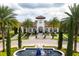 Beautiful clubhouse entrance with lush landscaping and a welcoming fountain at 8419 Pippen Dr, Orlando, FL 32836