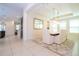 Elegant dining room with a stone table, white chairs, and a stylish chandelier at 8419 Pippen Dr, Orlando, FL 32836