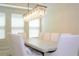 Bright dining area featuring a stone table, white chairs, and modern lighting fixture at 8419 Pippen Dr, Orlando, FL 32836