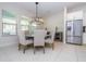 An eat-in kitchen offers a table with four chairs and a modern chandelier at 8419 Pippen Dr, Orlando, FL 32836