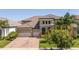Charming two-story home featuring a brick-paved driveway, lush landscaping, and an attached three-car garage at 8419 Pippen Dr, Orlando, FL 32836