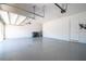 Spacious two car garage with a sealed concrete floor, painted walls, and overhead lighting at 8419 Pippen Dr, Orlando, FL 32836