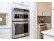 This kitchen features stainless steel appliances, including a double oven and wine cooler at 8419 Pippen Dr, Orlando, FL 32836