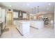 A large kitchen with stainless steel appliances and islands opens to a dining area with a dining table at 8419 Pippen Dr, Orlando, FL 32836