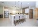 Modern kitchen with stainless steel appliances, a large island, and stylish pendant lights at 8419 Pippen Dr, Orlando, FL 32836