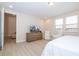 Bright main bedroom with wood flooring, a sitting area, and views from large windows at 8419 Pippen Dr, Orlando, FL 32836
