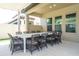 Expansive outdoor dining area with seating for twelve under a covered patio, perfect for entertaining at 8419 Pippen Dr, Orlando, FL 32836