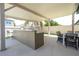 Well-equipped outdoor kitchen with bar seating and dining area for alfresco entertaining and relaxation at 8419 Pippen Dr, Orlando, FL 32836