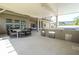 Extensive outdoor kitchen with grill, refrigerator, storage, bar, and dining area for entertainment at 8419 Pippen Dr, Orlando, FL 32836