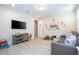 Bright playroom featuring light wood floors, a comfortable sofa, and a large television at 8419 Pippen Dr, Orlando, FL 32836
