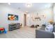 Bright playroom featuring light wood floors, a comfortable sofa, and a large television at 8419 Pippen Dr, Orlando, FL 32836