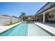 Long backyard pool with integrated spa, sun loungers, covered bar, outdoor kitchen, and entertainment area at 8419 Pippen Dr, Orlando, FL 32836