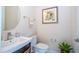 A half bathroom showcases a sink, toilet, mirror, and decorative artwork at 8419 Pippen Dr, Orlando, FL 32836