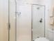 Glass-enclosed shower with chrome hardware, tiled walls, and integrated shelving for toiletries at 8419 Pippen Dr, Orlando, FL 32836