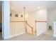 Upstairs landing featuring a staircase, windows for natural light, and light wood flooring throughout at 8419 Pippen Dr, Orlando, FL 32836