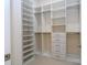 Expansive walk-in closet with built-in shelving, hanging rods, and drawer storage system at 8419 Pippen Dr, Orlando, FL 32836