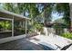 Landscaped backyard with screened lanai and hardscape patio at 920 Cool Springs Cir, Ocoee, FL 34761
