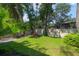A spacious, grassy backyard with mature trees and privacy fence at 920 Cool Springs Cir, Ocoee, FL 34761