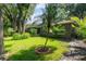 Home's backyard features lush landscaping and mature trees at 920 Cool Springs Cir, Ocoee, FL 34761