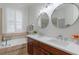 Bathroom featuring a double sink vanity, soaking tub, and modern finishes at 920 Cool Springs Cir, Ocoee, FL 34761