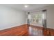 A bedroom with rich hardwood floors, a sun-filled window, and an airy ambiance at 920 Cool Springs Cir, Ocoee, FL 34761