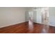 Bedroom with rich hardwood floors, an open doorway, and a view to the ensuite bath and sitting room at 920 Cool Springs Cir, Ocoee, FL 34761