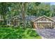 Beautiful single-story home with mature trees, well-maintained lawn, and a two-car garage on a sunny day at 920 Cool Springs Cir, Ocoee, FL 34761
