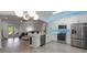 Bright kitchen with stainless appliances, a breakfast bar, and open view to a living room with outdoor access at 920 Cool Springs Cir, Ocoee, FL 34761