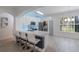 Modern kitchen features white cabinets, stainless steel appliances, and a breakfast bar with seating for four at 920 Cool Springs Cir, Ocoee, FL 34761