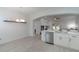 Bright kitchen with stainless dishwasher and open view to a dining room, fireplace, and living room at 920 Cool Springs Cir, Ocoee, FL 34761
