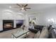 Living room features a fireplace, modern furniture, and access to an outdoor patio through glass doors at 920 Cool Springs Cir, Ocoee, FL 34761