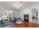 Cozy living room with hardwood floors, fireplace, and ample natural light at 920 Cool Springs Cir, Ocoee, FL 34761